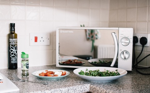 two-white-ceramic-plates-near-microwave-on-counter-top-1287150